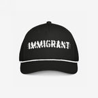 Black trucker-style Immigrant Hat with a white rope detail and IMMIGRANT in distressed font, featuring barbed-wire lines. A bold statement piece for activists, blending style with protest.