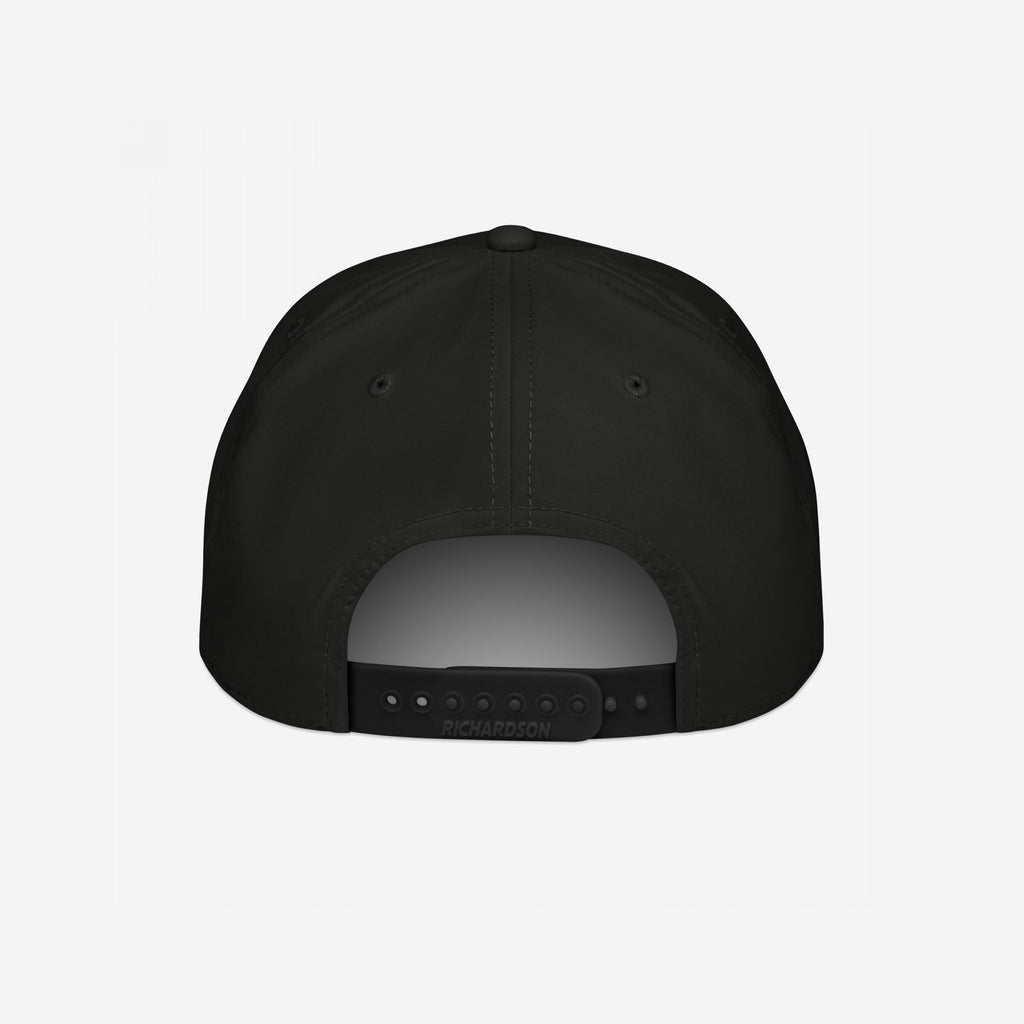 Back view of the Immigrant Hat, a black six-panel snapback with RICHARDSON on the adjustable strap. Features small ventilation eyelets and embodies rebellion with its bold stenciled barbed wire design.