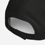 Immigrant Hat with adjustable snapback strap, showcasing rear panel stitching and ventilation eyelets, embodies defiance with its stenciled barbed wire design, reflecting activism and resistance against oppressive norms.