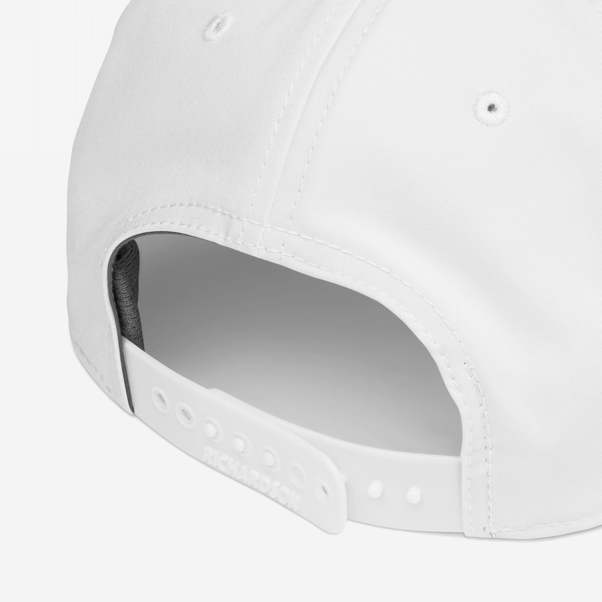 The Immigrant Hat features a white snap-back design with five fabric panels and adjustable strap, highlighted by a bold barbed wire pattern, symbolizing defiance and activism.