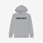 Immigrant Hoodie features a light-gray design with a front kangaroo pocket, adorned with IMMIGRANT in distressed, stenciled black font, symbolizing resistance and solidarity with immigrant communities.
