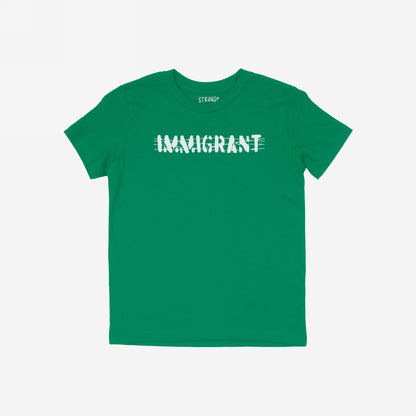 Green Immigrant Shirt featuring a distressed white “IMMIGRANT” print with a line through it, symbolizing resilience. Designed for activists and allies, embodying strength and unity in the fight for justice.
