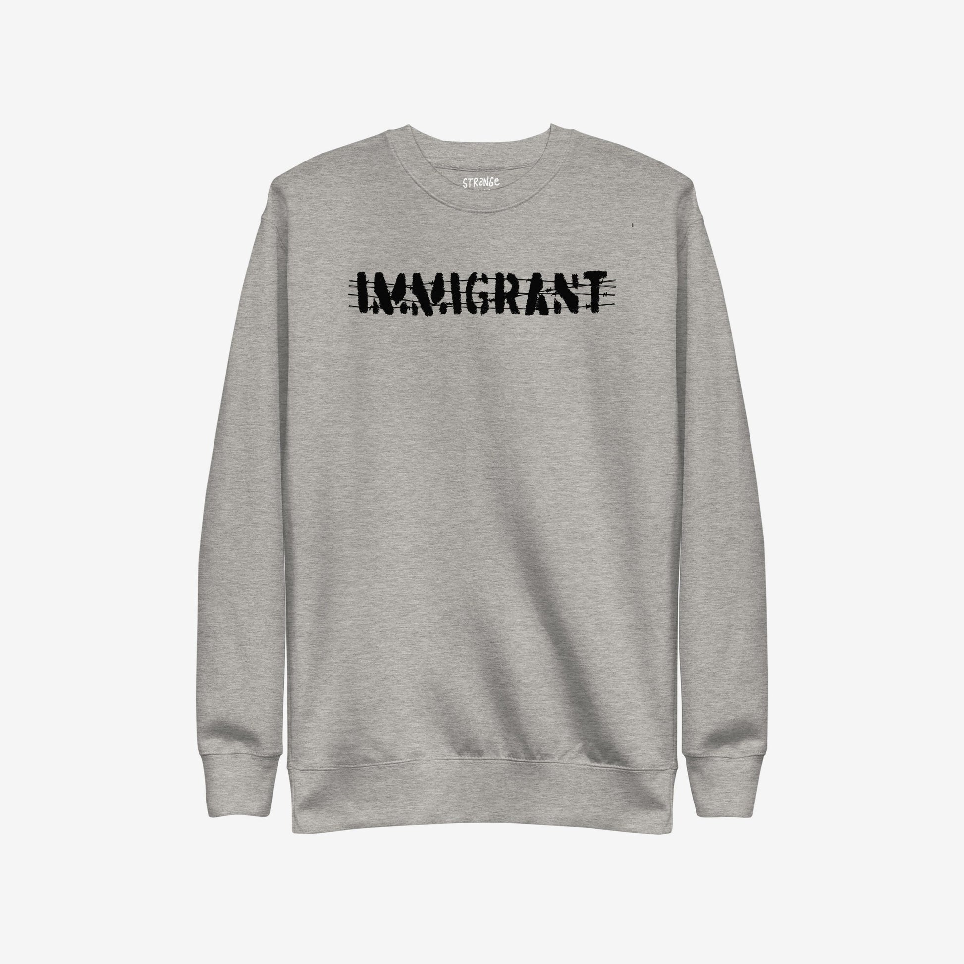 Light-grey Immigrant Hoodie & Sweatshirt features bold, distressed IMMIGRANT lettering with slash-through style, embodying activism and solidarity. Small label on neckline enhances its statement-making design. Unisex fit encourages unity.