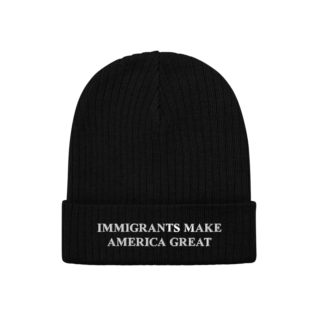 Black knit cuffed beanie hat with “IMMIGRANTS MAKE AMERICA GREAT” embroidered in white on the cuff, representing solidari