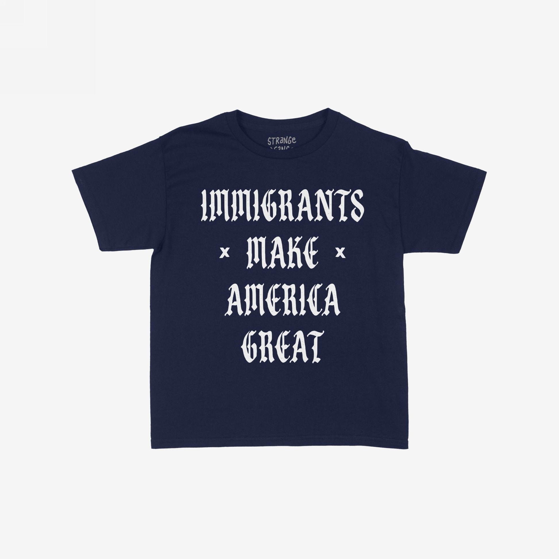 Immigrants Make America Great T-shirt featuring bold white Old English text on a navy-blue background, symbolizing solidarity and resistance against xenophobia and racism. Collar label reads “STRANGE GOODS.”