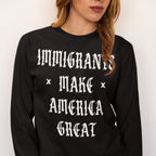 The Immigrants Make America Great Shirt features a bold statement in white Old English font on a black long-sleeve, advocating for dignity and justice, supporting equality and inclusion.