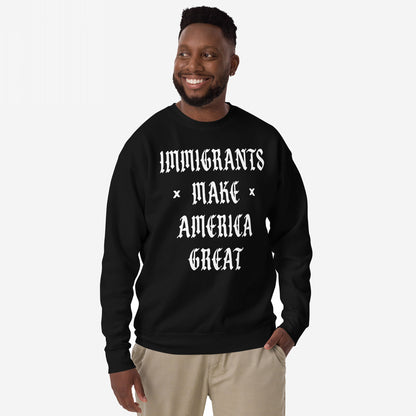 Smiling man models the Immigrants Make America Great Sweatshirt featuring bold white Old English text, advocating for immigrant pride and protest against racism and nationalism.