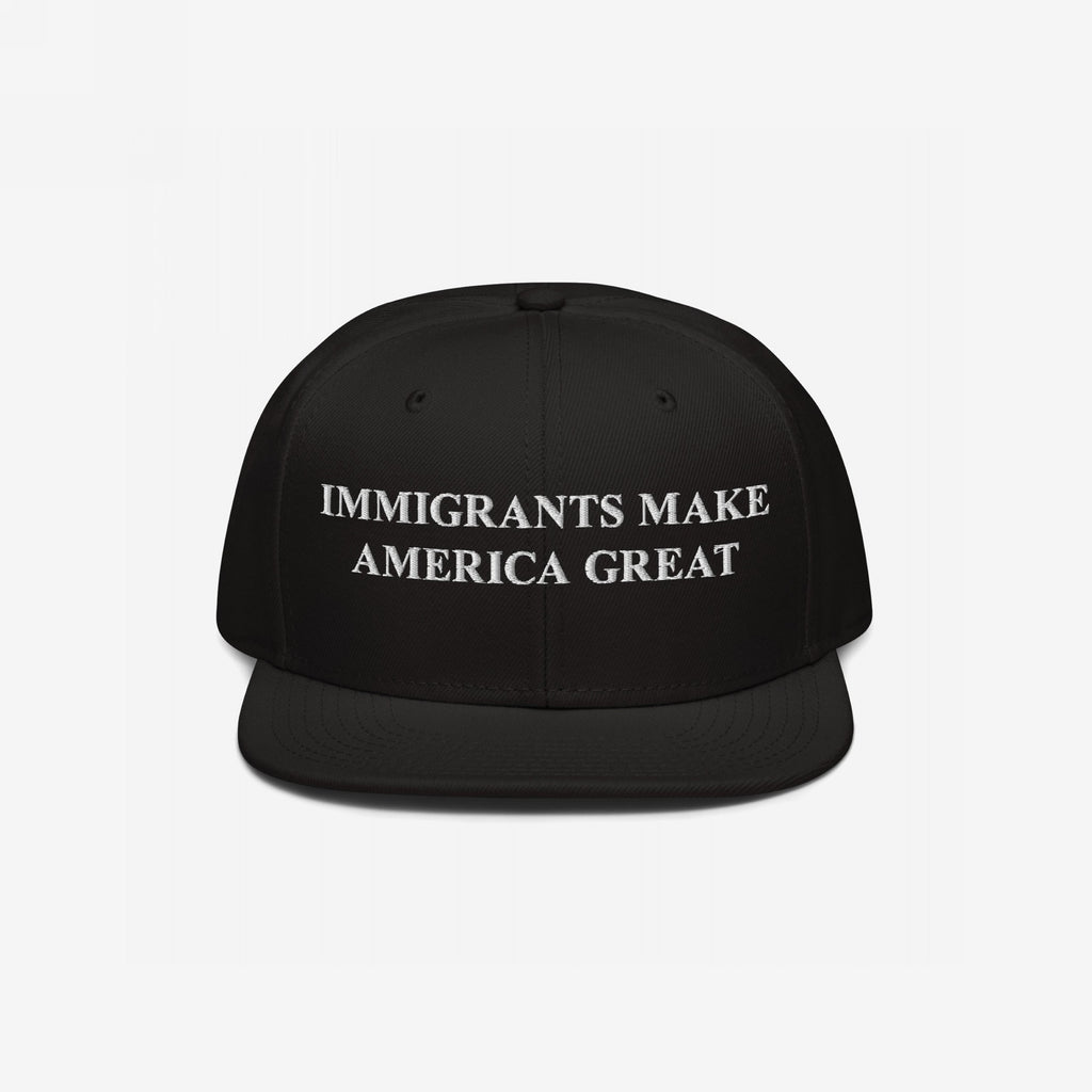 The Immigrants Make America Great Hat features bold white embroidery on a black snapback, symbolizing solidarity and advocacy for immigrant rights and social justice.