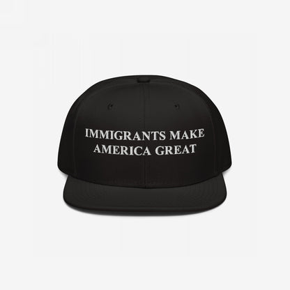 Black snapback hat with bold white embroidery stating IMMIGRANTS MAKE AMERICA GREAT, symbolizing advocacy for immigrant rights. Perfect for everyday wear or rallies, aligning with a message of equality and resistance.