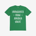 Plain green T-shirt with bold white slogan IMMIGRANTS × MAKE × AMERICA GREAT in Old English style, symbolizing protest and unity. Part of a collection supporting immigrant rights and justice.