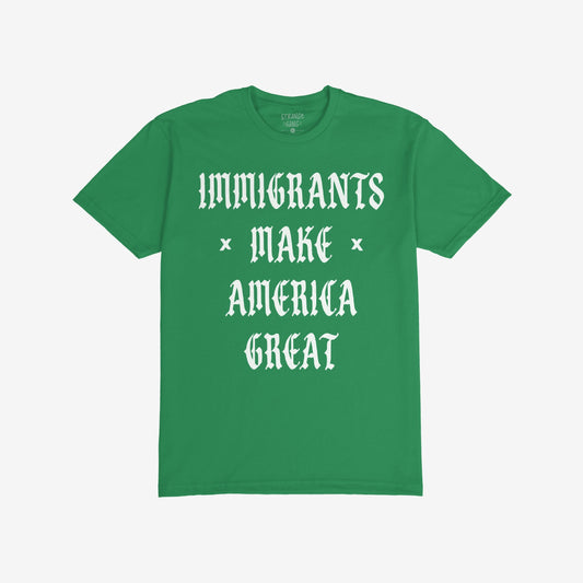 Plain green T-shirt with bold white slogan IMMIGRANTS × MAKE × AMERICA GREAT in Old English style, symbolizing protest and unity. Part of a collection supporting immigrant rights and justice.