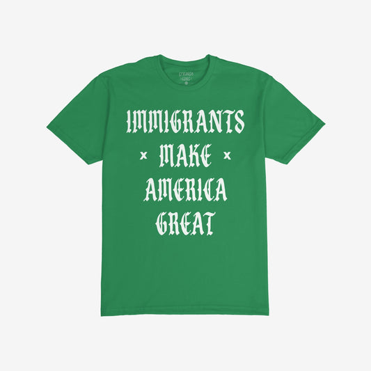 Immigrants Make America Great T-shirt featuring bold white Old English-style font, celebrates immigrant contributions and opposes xenophobia. The slogan is printed on the front of a plain green shirt.