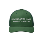 Immigrants Make America Great Hat: Green trucker cap featuring bold white embroidered text, promoting inclusivity and standin