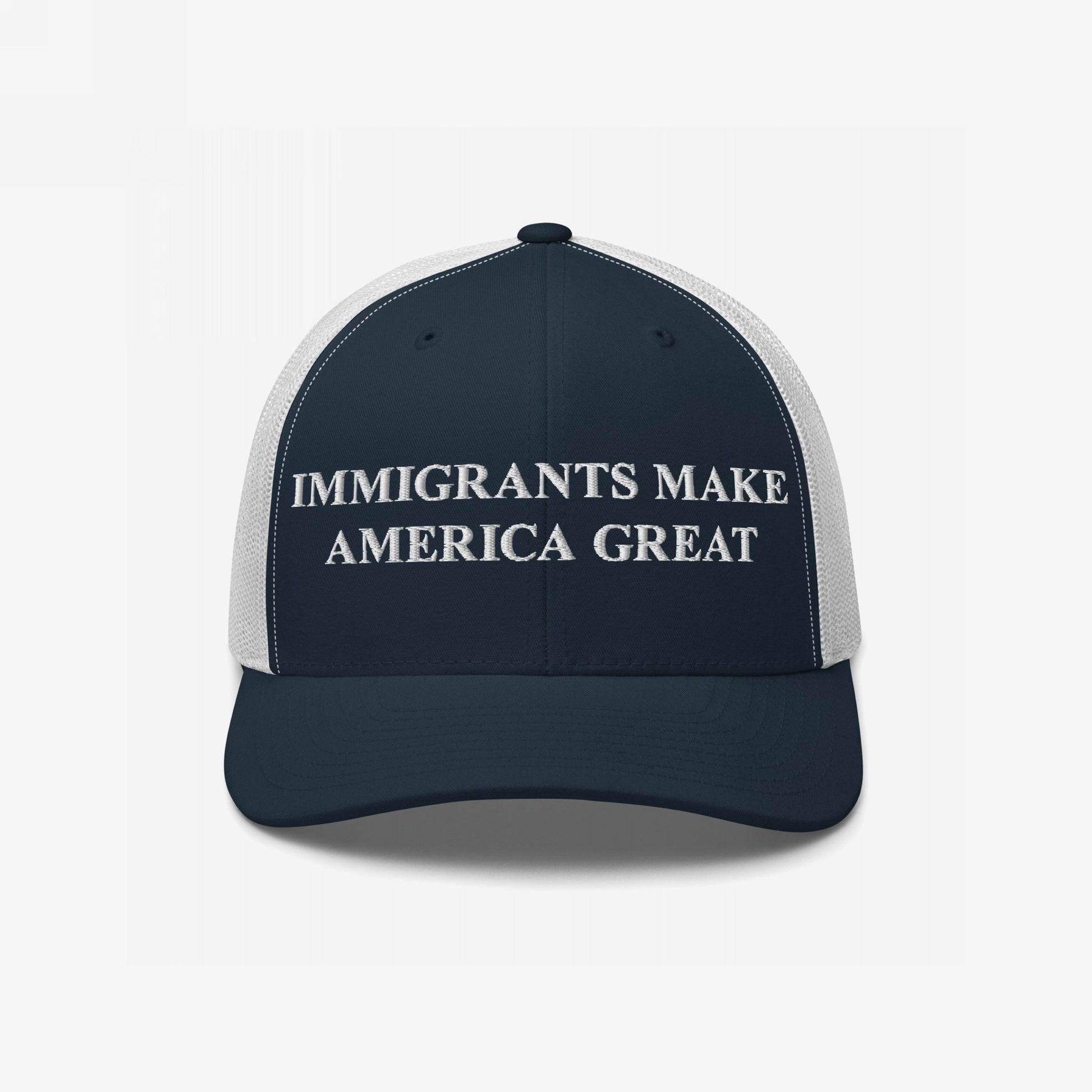 Navy-blue-and-white mesh trucker cap with “IMMIGRANTS MAKE AMERICA GREAT” embroidered boldly, embodying a message of equality and standing against xenophobia. Ideal for rallies or everyday wear.