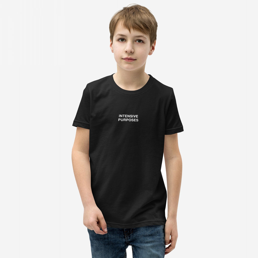 Young boy wearing the Intensive Purposes T-shirt, featuring the phrase INTENSIVE PURPOSES in white text on a black background, styled humorously for grammar enthusiasts and those who embrace linguistic quirks.
