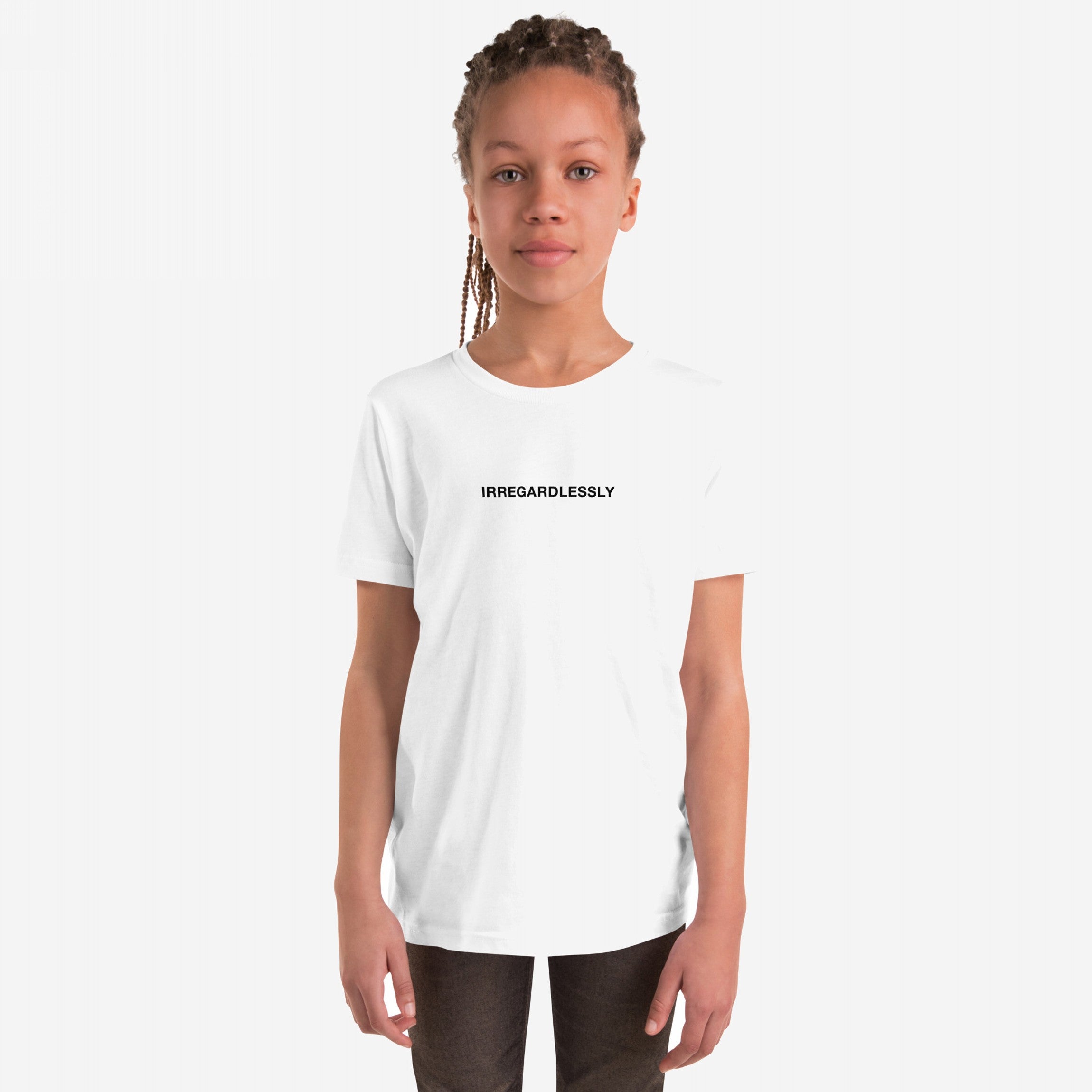 Young person in a white Irregardlessly T-shirt, featuring small black text, standing confidently with relaxed expression. Thin braids fall past shoulders. Perfect for fans of ironic humor and playful grammar.