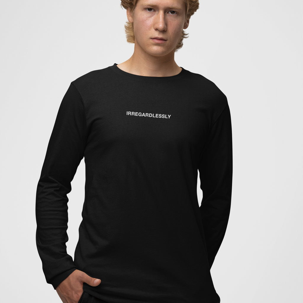 Young man in a black Irregardlessly T-shirt, standing confidently, illustrating ironic defiance and playful language rebellion. A nod to fans of wit and lexical chaos.