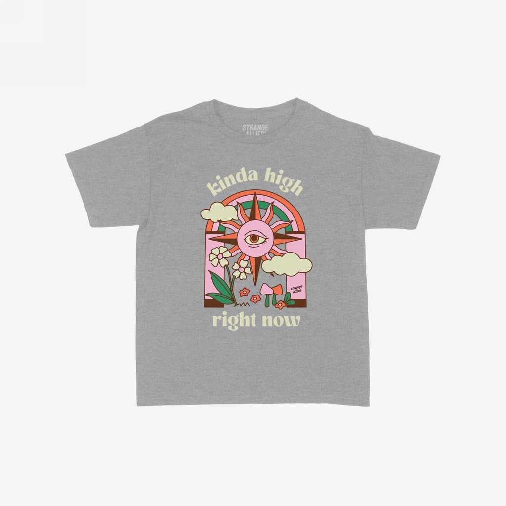 The Kinda High Women's Baby Tee features a retro graphic with a sun, rainbow, clouds, and mushrooms, embodying playful vibes. The phrases kinda high and right now accompany the art.