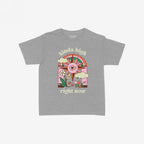 The Kinda High Women's Baby Tee features a retro graphic with a sun, rainbow, clouds, and mushrooms, embodying playful vibes. The phrases kinda high and right now accompany the art.