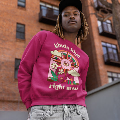 Young man models the Kinda High Right Now sweatshirt, featuring a psychedelic sun and whimsical design, perfect for free-spirited individuals who embrace creativity and individuality.
