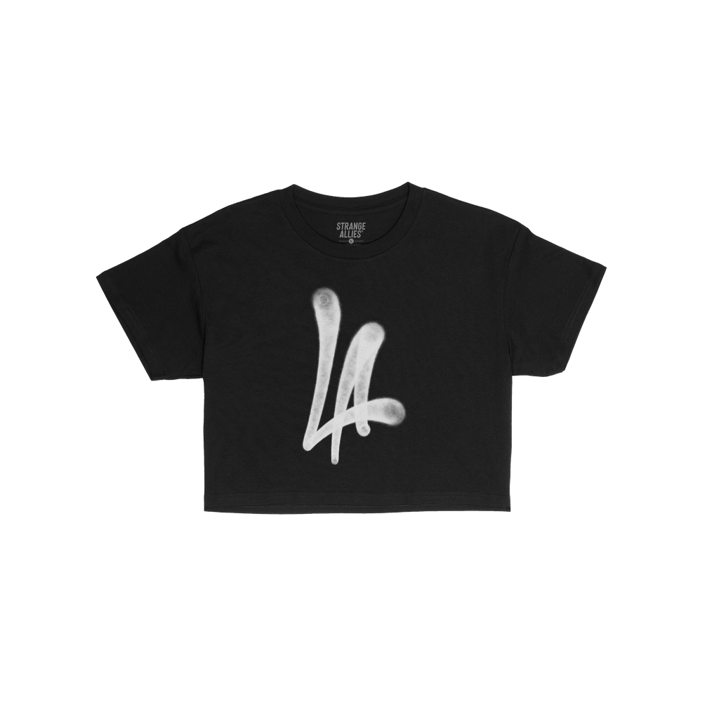 LA Handstyle Women's Baby Tee featuring a bold, white spray-paint “LA” graphic in a dripping tag design on a black short-