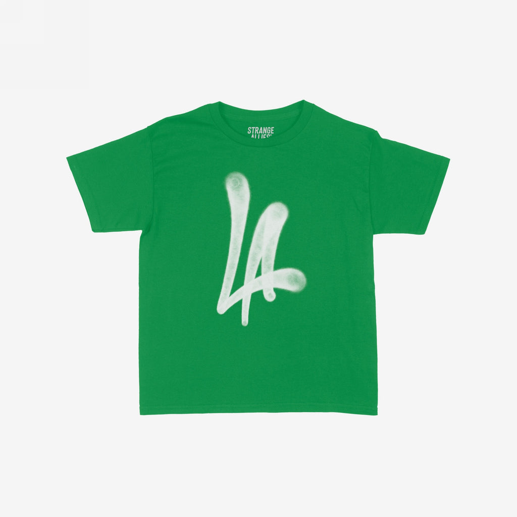 LA Handstyle Women's Baby Tee in bright kelly-green, featuring a prominent graffiti-inspired LA logo in soft white. The label STRANGE ALLIES is visible inside the collar.