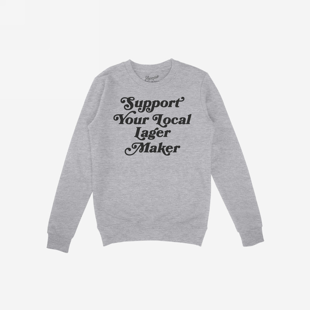 Support Your Local Lager Maker Hoodie & Sweatshirt features a vintage-style script promoting local brewers, embodying a spirited nod to craft beer culture. Laid flat, showcasing its cozy, unisex design.