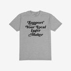 Light-gray T-shirt reading “Support Your Local Lager Maker” in black, stylized lettering, embodying a commitment to local brewers. Ideal for those passionate about craft beer and community support.