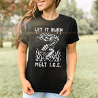 Woman wearing Let It Burn / Melt ICE Women's Baby Tee featuring Molotov cocktail graphic and text. The fitted black tee complements her casual jeans in a grassy, tree-lined setting.