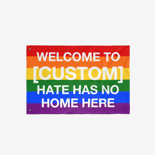 Custom Hate Has No Home Here Pride Flag showcasing a customizable welcome message on rainbow stripes, symbolizing love and unity. Ideal for personalizing with your city name, perfect for outdoor display.