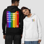 Two people model the Custom Hate Has No Home Here Pride Hoodie, featuring bold rainbow graphics and slogans, embodying social justice and LGBTQ+ support, with options for city customization.