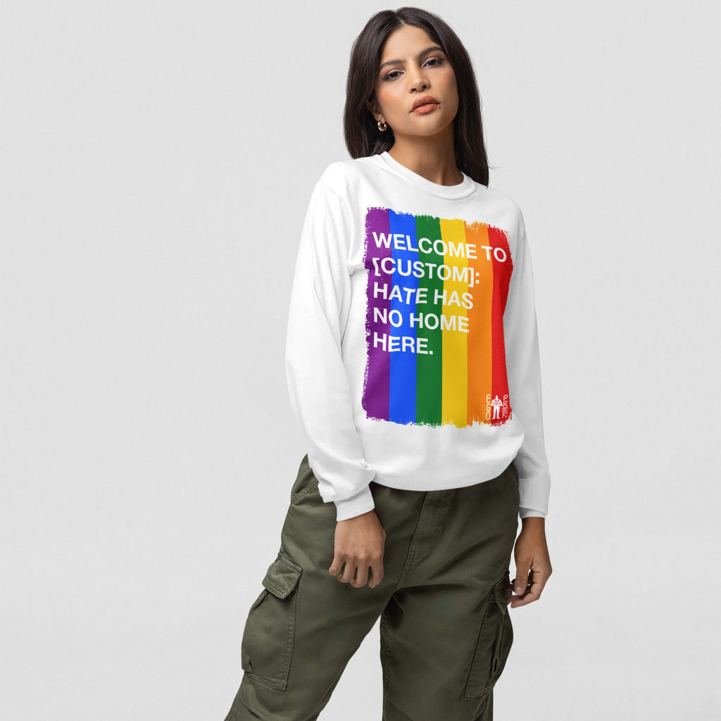 Person in olive cargo pants and a white sweatshirt featuring a rainbow block and WELCOME TO [CUSTOM]: HATE HAS NO HOME HERE text, showcasing the Custom Hate Has No Home Here Pride Long Sleeve T-shirt.