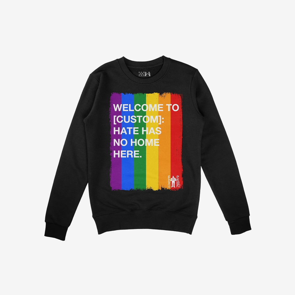 Custom Hate Has No Home Here Pride Sweatshirt featuring a bold rainbow panel and empowering message, promoting inclusivity and LGBTQ+ pride. Laid flat, highlighting the crewneck design and impactful graphics.