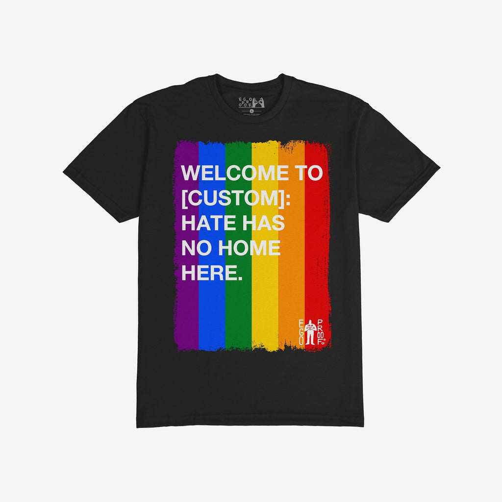 Custom Hate Has No Home Here Pride T-shirt featuring a vertical rainbow-stripe paint stroke graphic with a bold anti-hate message, embodying unity and inclusion.