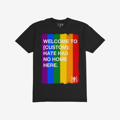 Custom Hate Has No Home Here Pride T-shirt featuring a vertical rainbow-stripe paint stroke graphic with a bold anti-hate message, embodying unity and inclusion.