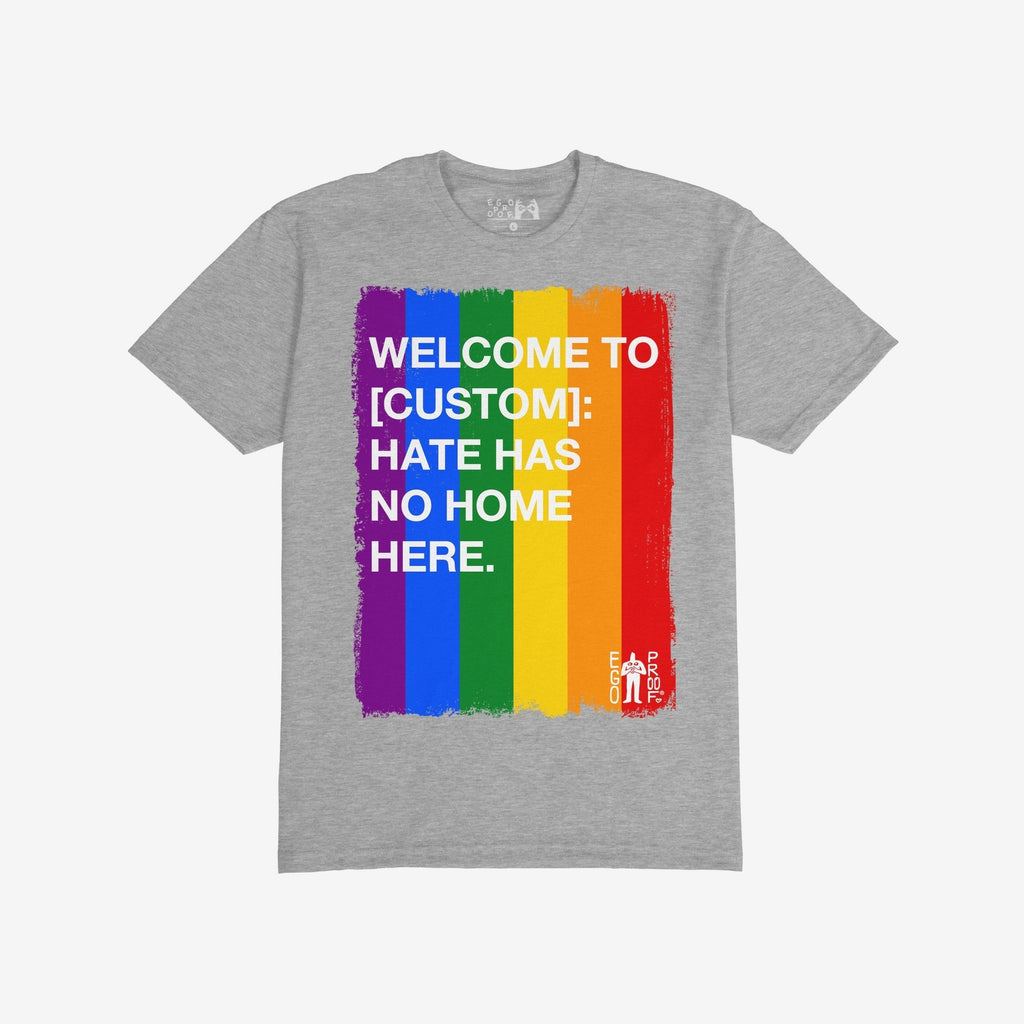 Custom Hate Has No Home Here Pride T-shirt featuring a vertical rainbow-stripe graphic with a bold, inclusive message promoting diversity and acceptance, perfect for expressing community support and unity.