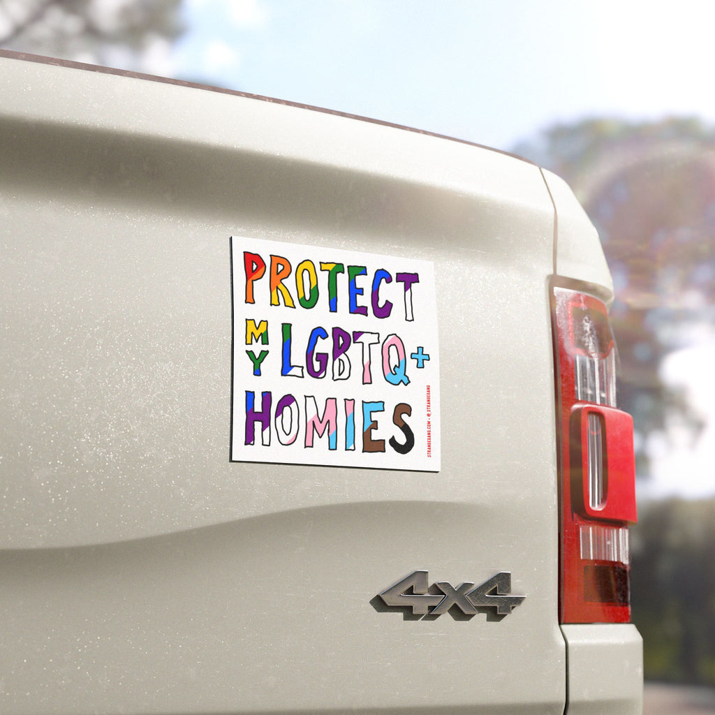 “Protect My LGBTQ+ Homies” sticker on a light-colored 4×4 pickup truck tailgate, showcasing hand-drawn, rainbow-style letters advocating for equality and supporting LGBTQ+ rights.