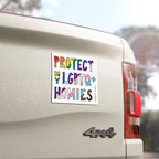 “Protect My LGBTQ+ Homies” sticker on a light-colored 4×4 pickup truck tailgate, showcasing hand-drawn, rainbow-style letters advocating for equality and supporting LGBTQ+ rights.