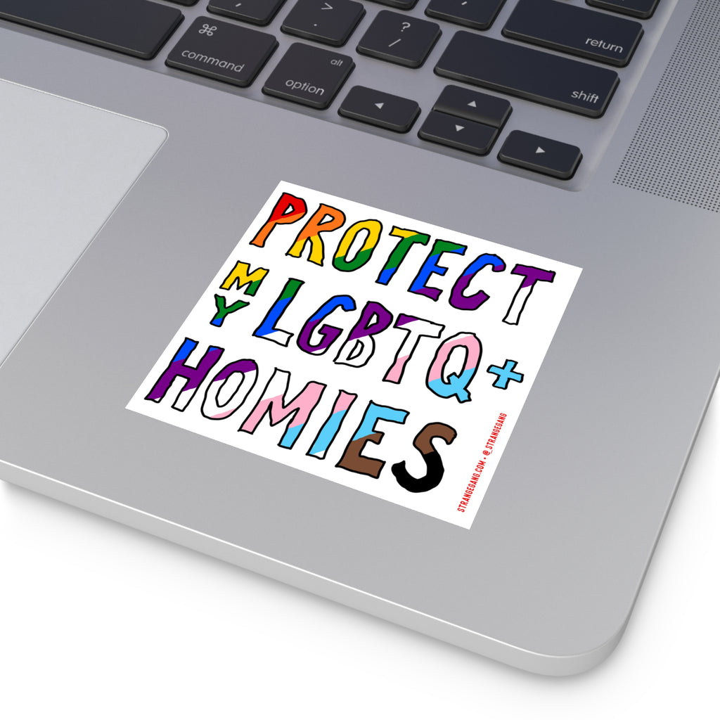 Silver laptop corner with a Protect My LGBTQ+ Homies sticker featuring hand-drawn letters in pride colors, emphasizing equality and allyship. Sticker credit: strangegang.com @_strangegang.