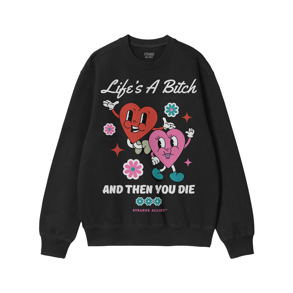 Black crewneck sweatshirt featuring the Life's A Bitch design with two smiling hearts, flowers, and sparkles, encapsulating a