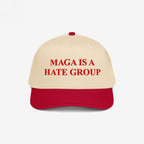 Two-tone MAGA Is A Hate Group hat with a red brim and light tan crown, featuring bold red embroidery, catering to progressive and equality-driven individuals challenging hate in politics.