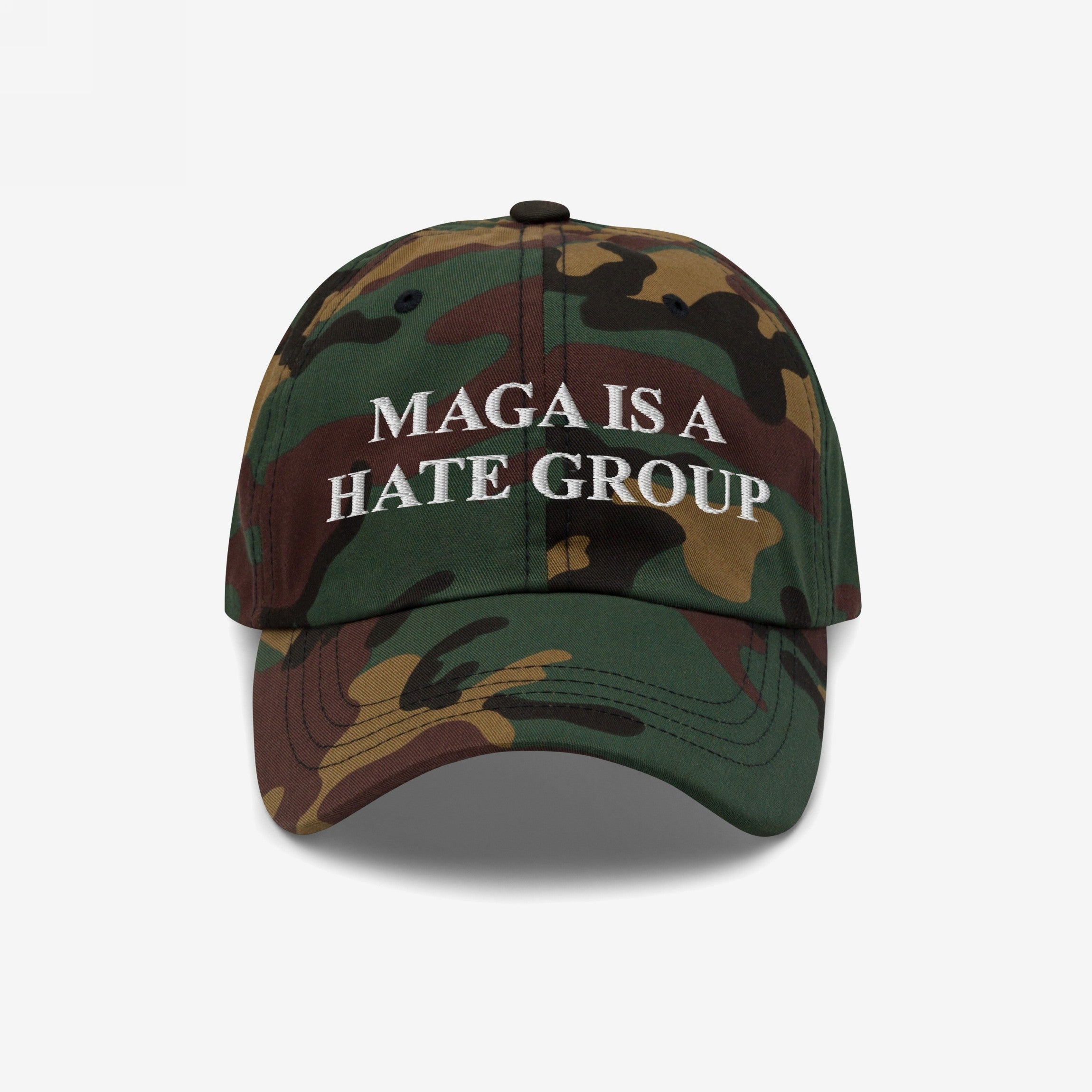 Camouflage-patterned baseball cap with MAGA IS A HATE GROUP in white embroidery, representing progressive activism and anti-fascism, suitable for protests and everyday wear.