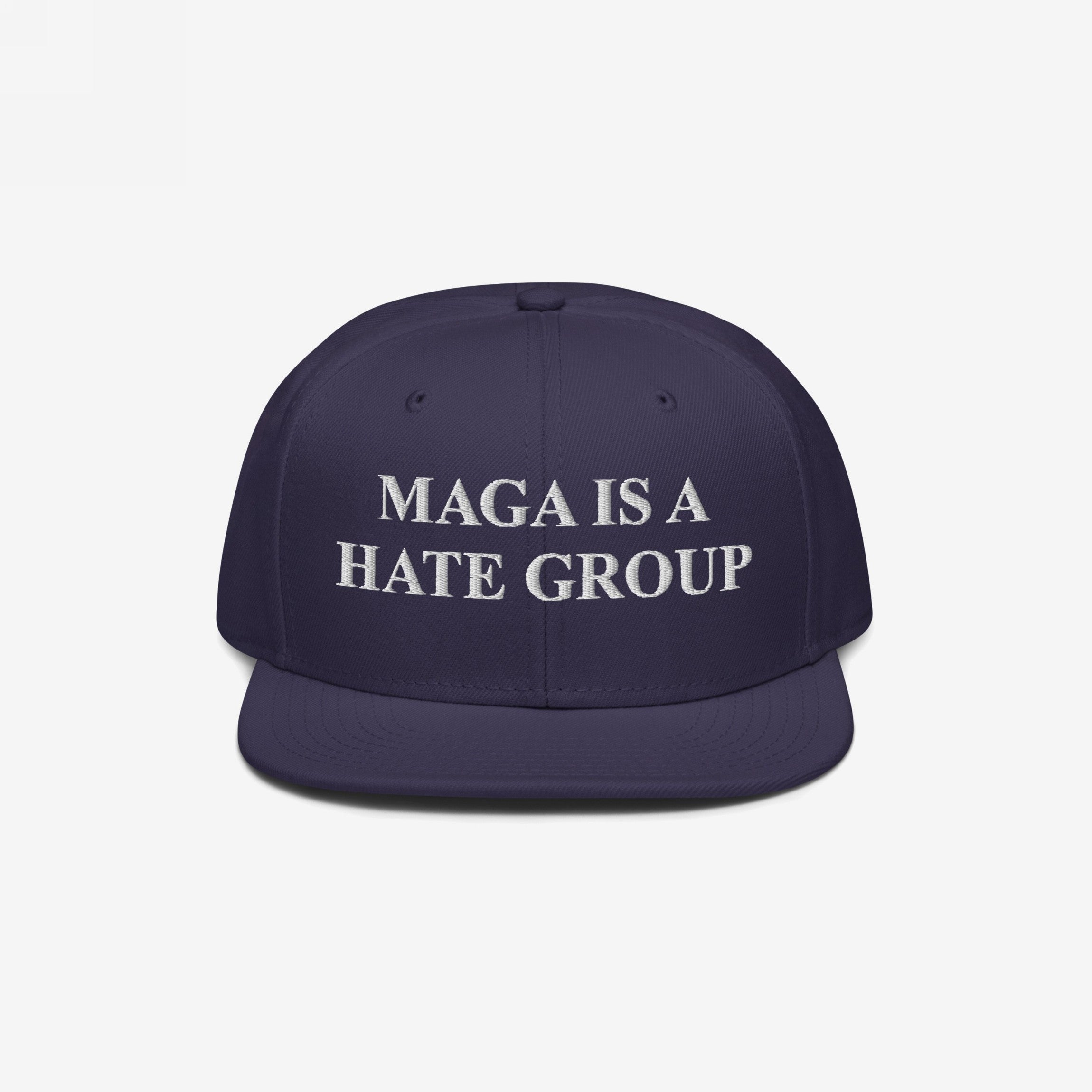 Navy-blue snapback cap with white embroidery reading MAGA Is A Hate Group, symbolizing progressive, anti-fascist, and equality support. Ideal for protests or everyday wear.