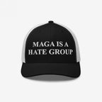 Black-and-white trucker-style cap with “MAGA IS A HATE GROUP” embroidered on the front. Ideal for progressives and equality supporters, this cap embodies anti-fascism and political activism.