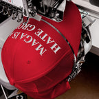 Red trucker cap in embroidery machine, stitching MAGA Is A Hate Group in white, embodying progressive values and resistance against hate, perfect for protests and everyday wear.