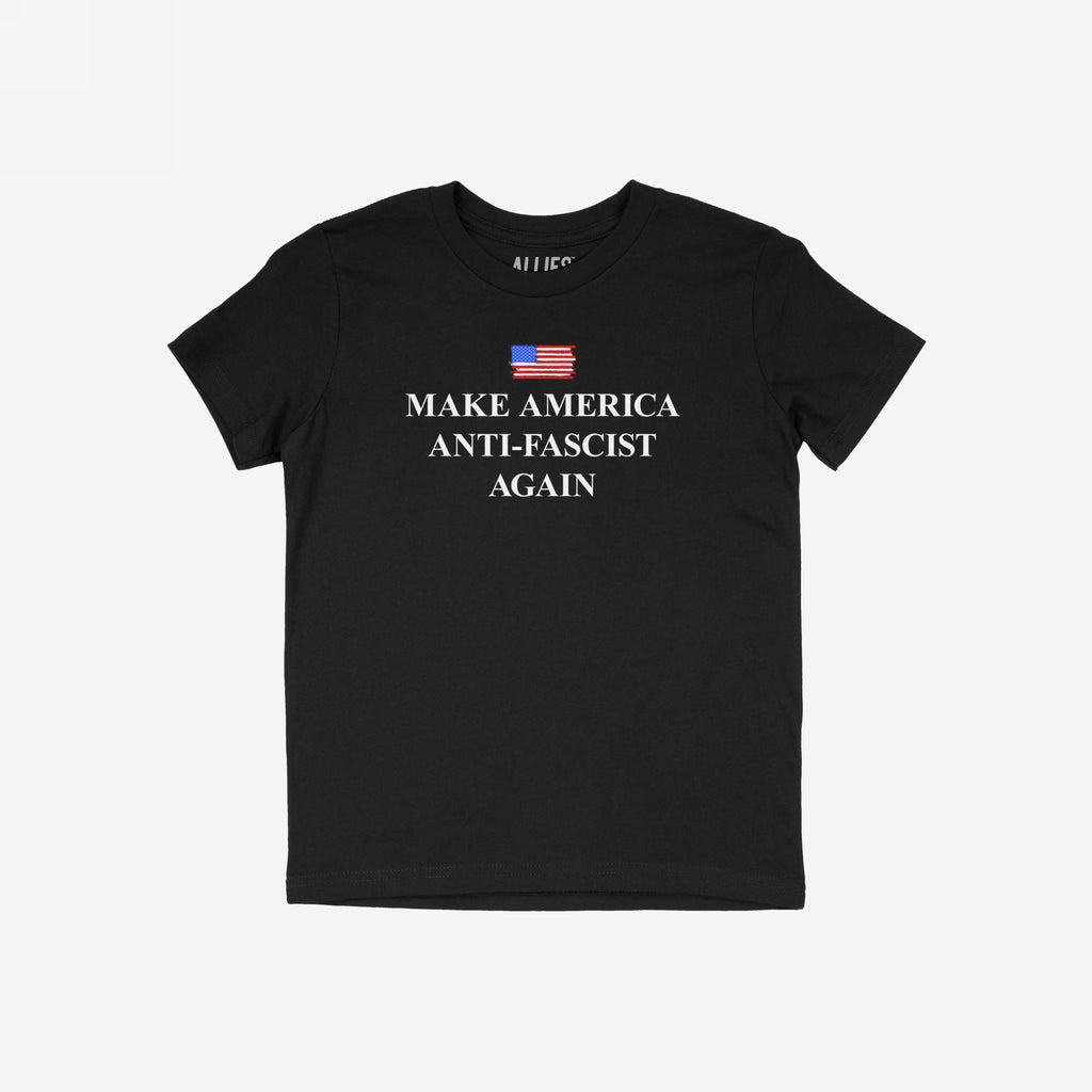 Black T-shirt featuring a distressed American flag and bold serif text: MAKE AMERICA ANTI-FASCIST AGAIN, expressing defiance against authoritarianism and supporting democratic values. Ideal for anti-fascists and progressives.