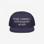 Dark navy-blue snapback hat with flat brim, featuring bold white embroidery reading “MAKE AMERICA ANTI-FASCIST AGAIN.” The Make America Anti-Fascist Again Hat boldly advocates for democracy and anti-authoritarianism.