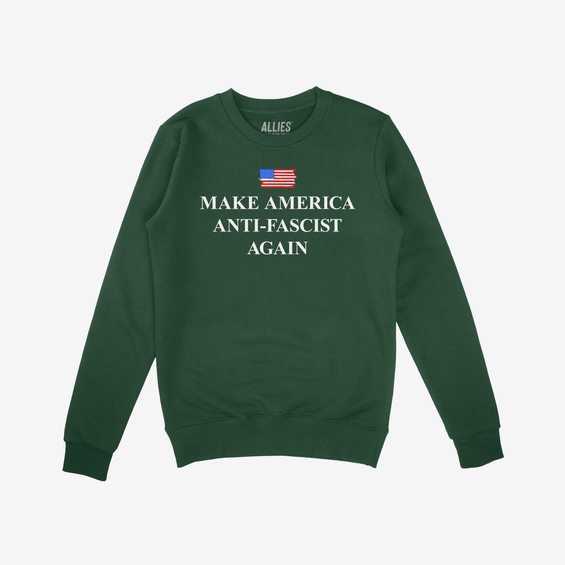 Dark-green crewneck sweatshirt titled Make America Anti-Fascist Again, featuring a small American flag and bold white slogan. Designed for those advocating democracy and civil rights.