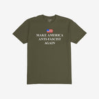 Make America Anti-Fascist Again T-shirt with a small U.S. flag and bold serif slogan, reflecting a stance against authoritarianism, showcasing the message above “STRANGE ALLIES” label inside the collar.