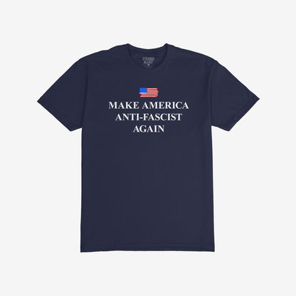 Navy-blue T-shirt featuring a distressed American flag and bold “MAKE AMERICA ANTI-FASCIST AGAIN” slogan, advocating against fascism and supporting equality.